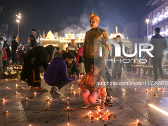 Tourists light candles on the day of Diwali in Srinagar, Indian Administered Kashmir, on October 31, 2024. (