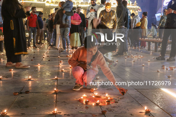 Tourists light candles on the day of Diwali in Srinagar, Indian Administered Kashmir, on October 31, 2024. 