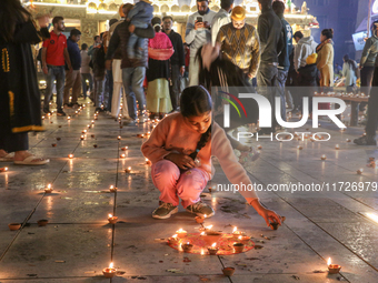 Tourists light candles on the day of Diwali in Srinagar, Indian Administered Kashmir, on October 31, 2024. (