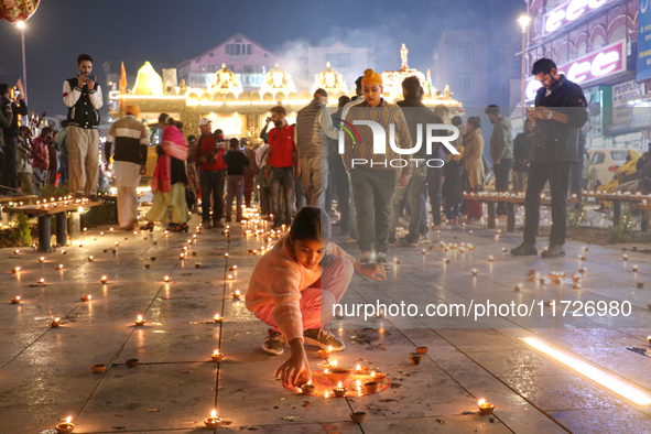 Tourists light candles on the day of Diwali in Srinagar, Indian Administered Kashmir, on October 31, 2024. 