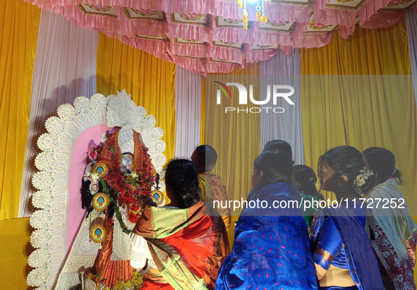 Devotees worship inside a Puja Pandal on the occasion of 'Diwali', the Hindu festival of lights, in Siliguri, India, on October 31, 2024. 