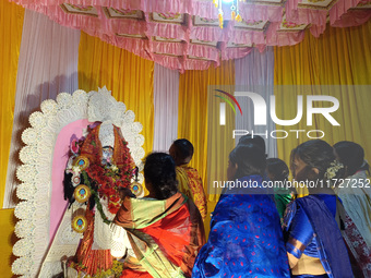 Devotees worship inside a Puja Pandal on the occasion of 'Diwali', the Hindu festival of lights, in Siliguri, India, on October 31, 2024. (