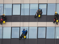 High rise window cleaners work at the office building in Krakow, Poland on October 31, 2024. (