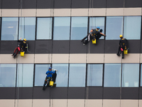 High rise window cleaners work at the office building in Krakow, Poland on October 31, 2024. (