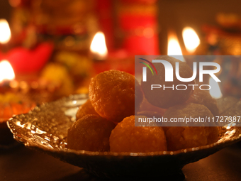 A bowl of ladoos (a traditional Indian sweet) is present during the festival of Diwali at a Hindu temple in Toronto, Ontario, Canada, on Oct...