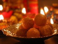 A bowl of ladoos (a traditional Indian sweet) is present during the festival of Diwali at a Hindu temple in Toronto, Ontario, Canada, on Oct...