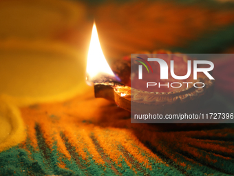 A diya (small clay lamp) sits by a rangoli design during the festival of Diwali at a Hindu temple in Toronto, Ontario, Canada, on October 31...