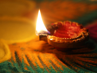 A diya (small clay lamp) sits by a rangoli design during the festival of Diwali at a Hindu temple in Toronto, Ontario, Canada, on October 31...