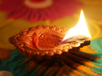 A diya (small clay lamp) sits by a rangoli design during the festival of Diwali at a Hindu temple in Toronto, Ontario, Canada, on October 31...