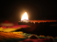 A diya (small clay lamp) sits by a rangoli design during the festival of Diwali at a Hindu temple in Toronto, Ontario, Canada, on October 31...