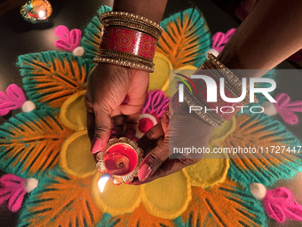 A Hindu devotee holds a diya (small clay lamp) during the festival of Diwali at a Hindu temple in Toronto, Ontario, Canada, on October 31, 2...