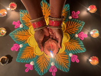 A Hindu devotee holds a diya (small clay lamp) during the festival of Diwali at a Hindu temple in Toronto, Ontario, Canada, on October 31, 2...