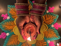 A Hindu devotee holds a diya (small clay lamp) during the festival of Diwali at a Hindu temple in Toronto, Ontario, Canada, on October 31, 2...