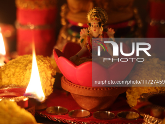 An idol of Goddess Lakshmi is surrounded by diyas (small clay lamps) during the festival of Diwali at a Hindu temple in Toronto, Ontario, Ca...