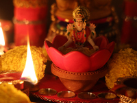 An idol of Goddess Lakshmi is surrounded by diyas (small clay lamps) during the festival of Diwali at a Hindu temple in Toronto, Ontario, Ca...