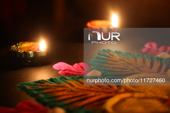 Diyas (small clay lamps) surround a rangoli design during the festival of Diwali at a Hindu temple in Toronto, Ontario, Canada, on October 3...