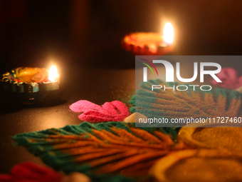 Diyas (small clay lamps) surround a rangoli design during the festival of Diwali at a Hindu temple in Toronto, Ontario, Canada, on October 3...