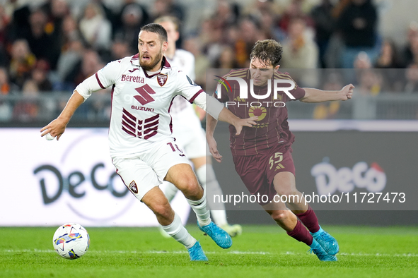 Nikola Vlasic of Torino FC and Tommaso Baldanzi of AS Roma compete for the ball during the Serie A Enilive match between Empoli FC and FC In...