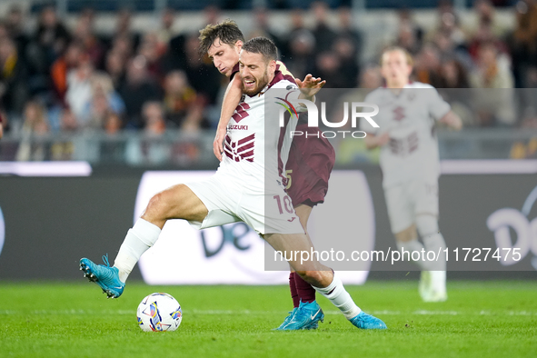 Nikola Vlasic of Torino FC and Tommaso Baldanzi of AS Roma compete for the ball during the Serie A Enilive match between Empoli FC and FC In...