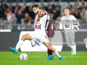 Nikola Vlasic of Torino FC and Tommaso Baldanzi of AS Roma compete for the ball during the Serie A Enilive match between Empoli FC and FC In...