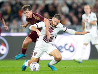 Nikola Vlasic of Torino FC and Tommaso Baldanzi of AS Roma compete for the ball during the Serie A Enilive match between Empoli FC and FC In...