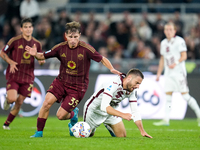 Nikola Vlasic of Torino FC and Tommaso Baldanzi of AS Roma compete for the ball during the Serie A Enilive match between Empoli FC and FC In...