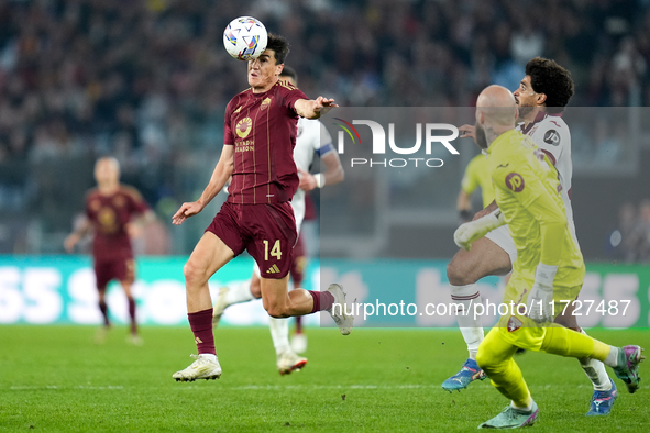 Eldor Shomurodov of AS Roma and Saul Coco of Torino FC compete for the ball during the Serie A Enilive match between Empoli FC and FC Intern...