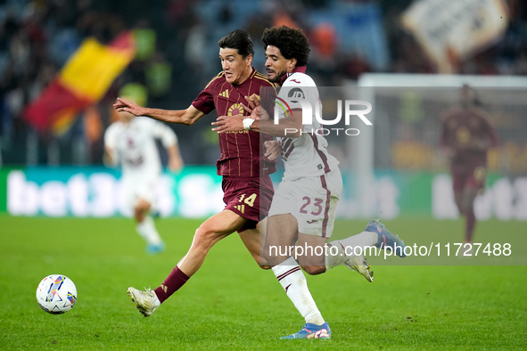 Eldor Shomurodov of AS Roma and Saul Coco of Torino FC compete for the ball during the Serie A Enilive match between Empoli FC and FC Intern...