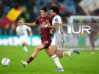 Eldor Shomurodov of AS Roma and Saul Coco of Torino FC compete for the ball during the Serie A Enilive match between Empoli FC and FC Intern...