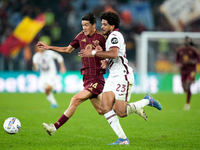 Eldor Shomurodov of AS Roma and Saul Coco of Torino FC compete for the ball during the Serie A Enilive match between Empoli FC and FC Intern...