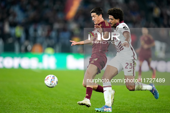 Eldor Shomurodov of AS Roma and Saul Coco of Torino FC compete for the ball during the Serie A Enilive match between Empoli FC and FC Intern...