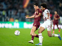 Eldor Shomurodov of AS Roma and Saul Coco of Torino FC compete for the ball during the Serie A Enilive match between Empoli FC and FC Intern...