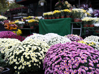 A stand with flowers and candles is next to the Rakowicki Cemetery during preparations for All Saints' Day in Krakow, Poland, on October 30,...