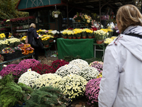 A stand with flowers and candles is next to the Rakowicki Cemetery during preparations for All Saints' Day in Krakow, Poland, on October 30,...