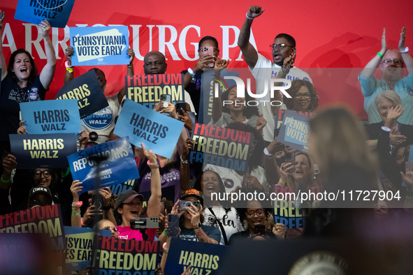 People cheer Vice President Kamala Harris as she speaks at a get out the vote rally in Harrisburg, PA, on October 30, 2024.  Harris and her...