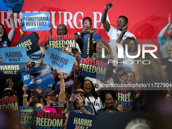 People cheer Vice President Kamala Harris as she speaks at a get out the vote rally in Harrisburg, PA, on October 30, 2024.  Harris and her...