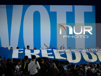 People unfurl a ''freedom'' banner at the conclusion od Vice President Kamala Harris' remarks at a get out the vote rally in Harrisburg, PA,...