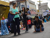 A devotee visits the Altar of Santa Muerte on his knees on Alfareria Street in the Tepito neighborhood to show devotion and give thanks for...