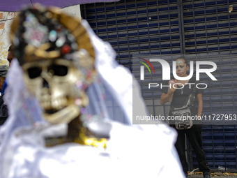 A devotee visits the altar of Santa Muerte located on Alfareria Street in the Tepito neighborhood to show their devotion and give thanks for...