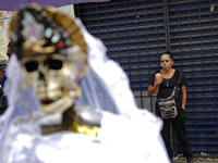 A devotee visits the altar of Santa Muerte located on Alfareria Street in the Tepito neighborhood to show their devotion and give thanks for...