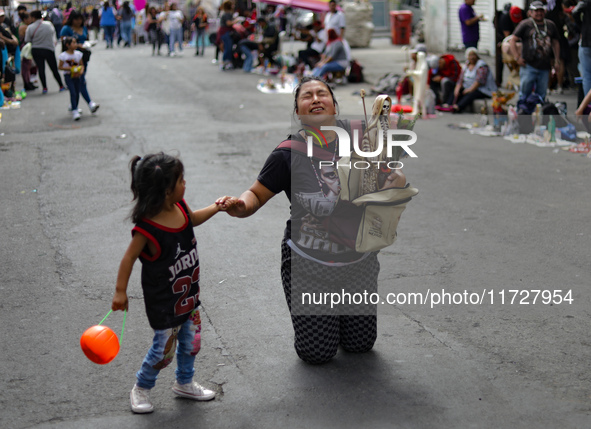 A devotee visits the Altar of Santa Muerte on his knees on Alfareria Street in the Tepito neighborhood to show devotion and give thanks for...