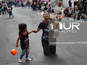 A devotee visits the Altar of Santa Muerte on his knees on Alfareria Street in the Tepito neighborhood to show devotion and give thanks for...