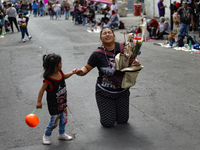 A devotee visits the Altar of Santa Muerte on his knees on Alfareria Street in the Tepito neighborhood to show devotion and give thanks for...