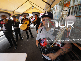 A devotee visits the altar of Santa Muerte located on Alfareria Street in the Tepito neighborhood to show their devotion and give thanks for...