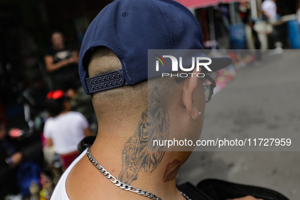 A tattoo of Santa Muerte is on the neck of a devotee attending the Altar of Santa Muerte on Alfareria Street in the Tepito neighborhood to s...