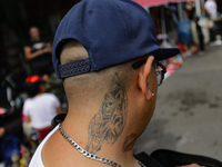 A tattoo of Santa Muerte is on the neck of a devotee attending the Altar of Santa Muerte on Alfareria Street in the Tepito neighborhood to s...