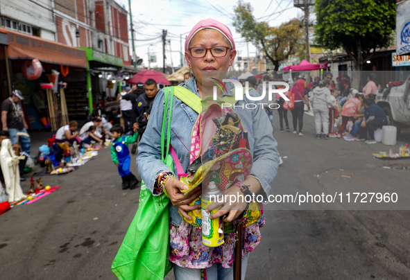 A devotee visits the altar of Santa Muerte located on Alfareria Street in the Tepito neighborhood to show their devotion and give thanks for...