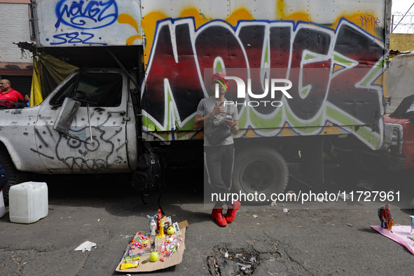 A devotee visits the altar of Santa Muerte located on Alfareria Street in the Tepito neighborhood to show their devotion and give thanks for...