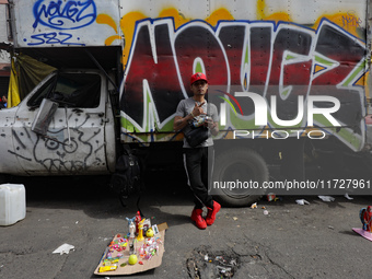 A devotee visits the altar of Santa Muerte located on Alfareria Street in the Tepito neighborhood to show their devotion and give thanks for...