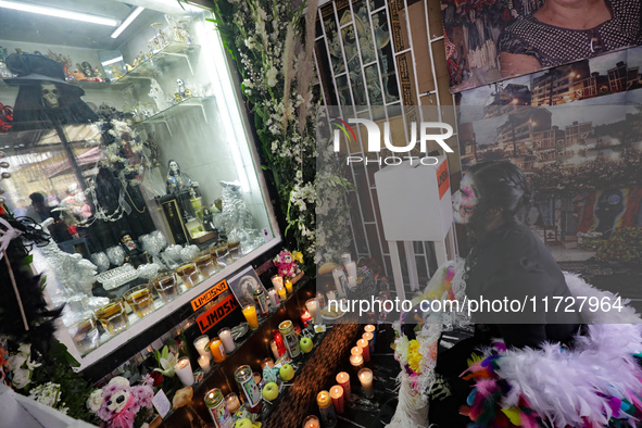 A devotee disguised as a catrina prays in front of Santa Muerte's altar in the Tepito neighborhood to show devotion and give thanks for favo...